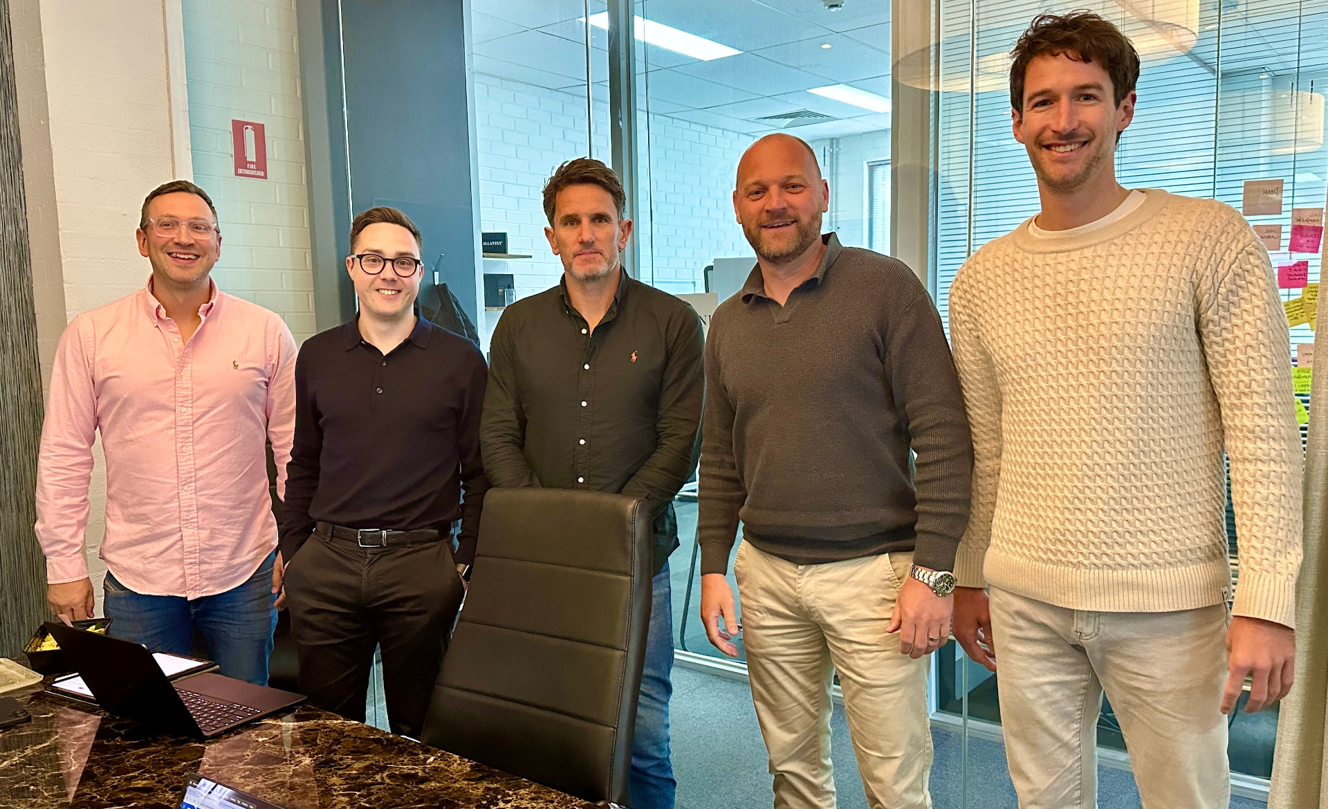 The BusinessAI team standing together in the office